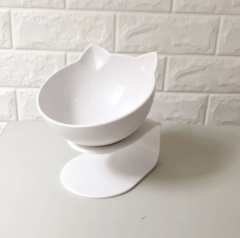 White ceramic bowl on a white surface with a white tiled wall background