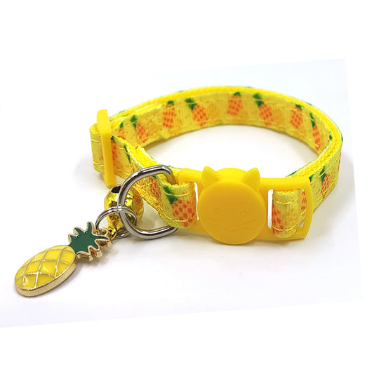 Yellow pineapple-patterned dog collar with a pineapple charm on a white background