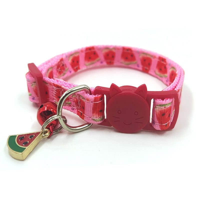Pink dog collar with watermelon pattern and cat-shaped buckle on a white background