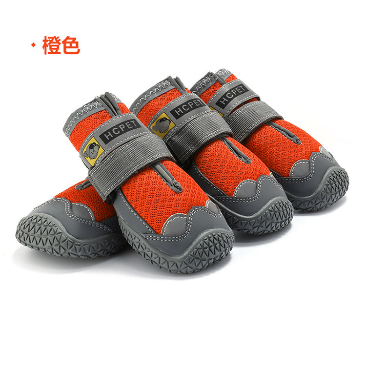 Orange and gray pet shoes with visible brand logo on a white background