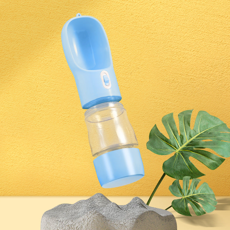 Dog drinking from portable travel water bottle outdoors