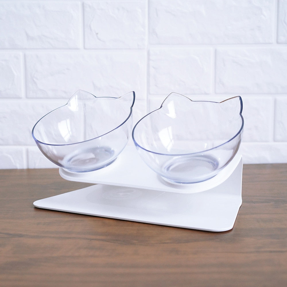 Cat-shaped clear bowls on a white stand against a white tiled wall.