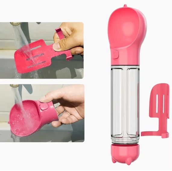 Pink kitchen tool with clear handle and attachments on a white background